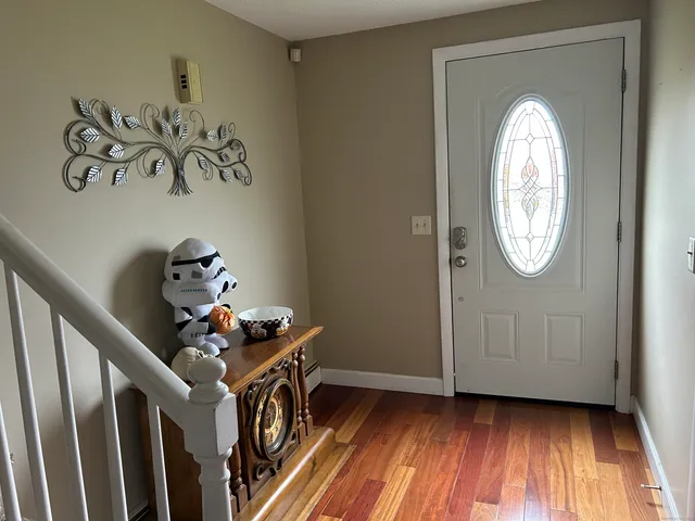 a view of an entryway with wooden floor