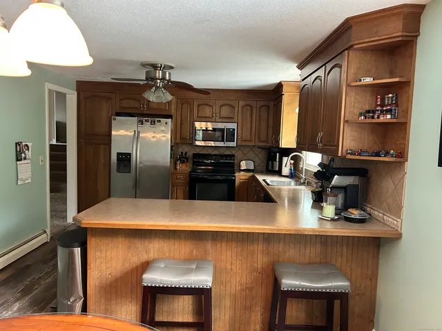 a kitchen with stainless steel appliances a sink and a refrigerator