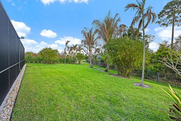 a very nice looking house with a big yard and large trees