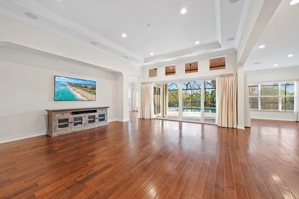 a living room with furniture and a wooden floor