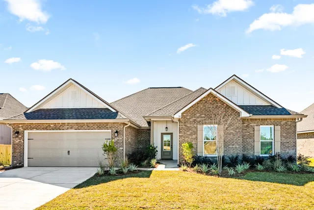 a front view of a house with a yard and table and chairs