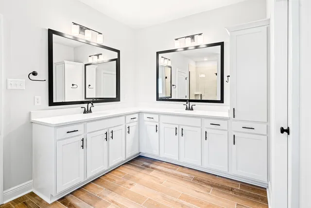 a spacious bathroom with double vanity sinks and a mirror