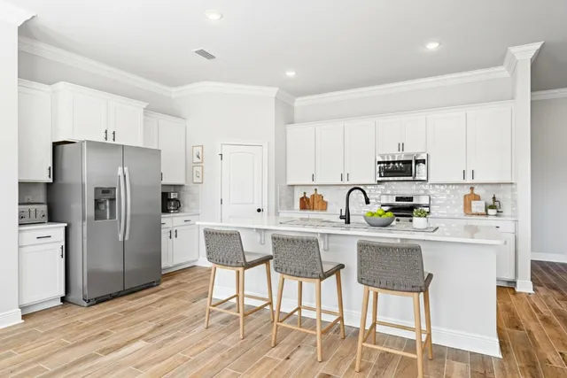 a kitchen with stainless steel appliances a refrigerator stove microwave and cabinets