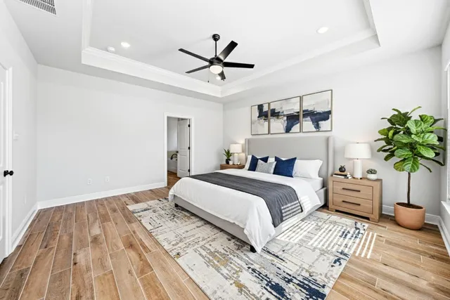 a bedroom with a bed and wooden floor