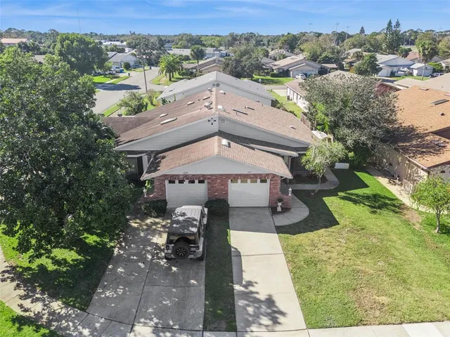 an aerial view of a house with a yard basket ball court and outdoor seating