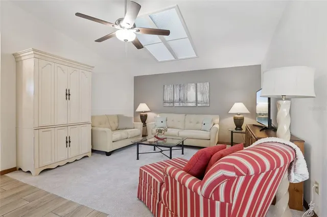 a spacious bedroom with a bed and a chandelier