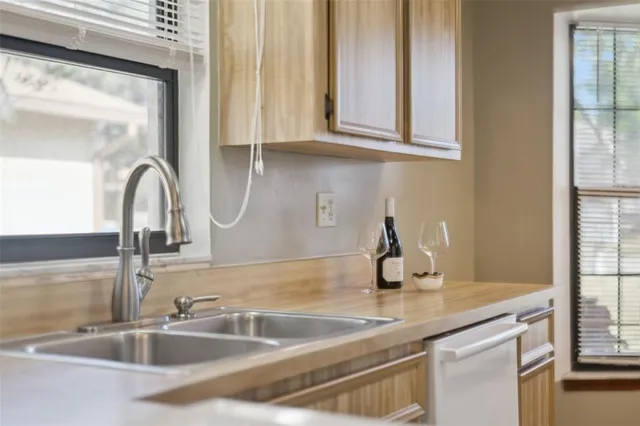 a large white bed sitting in a bedroom next to a window