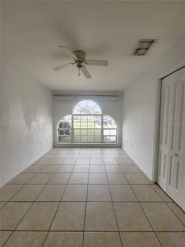 a view of an empty room and a window