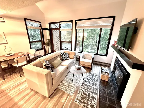 a living room with furniture tv and a large window