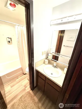 a bathroom with a sink a mirror and a shower