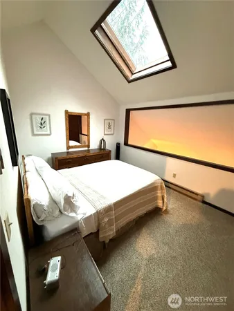 a bedroom with a bed and a night stand