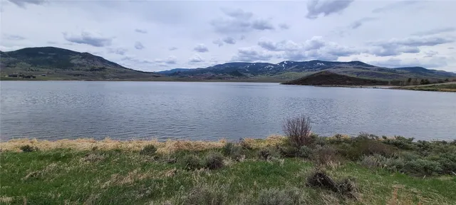a view of a lake with houses in the back