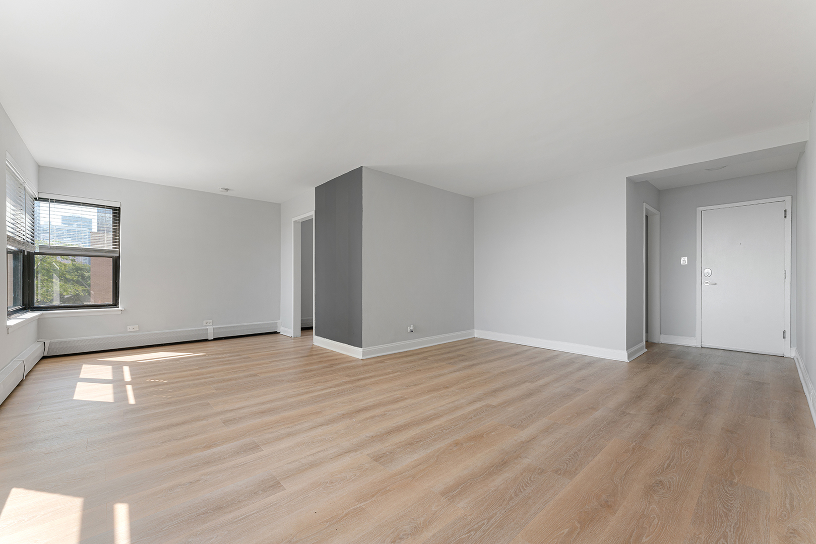 5858 North Sheridan Road, Unit 402 Chicago, IL 60660 - Photo 4 of 16 a view of an empty room with window and wooden floor