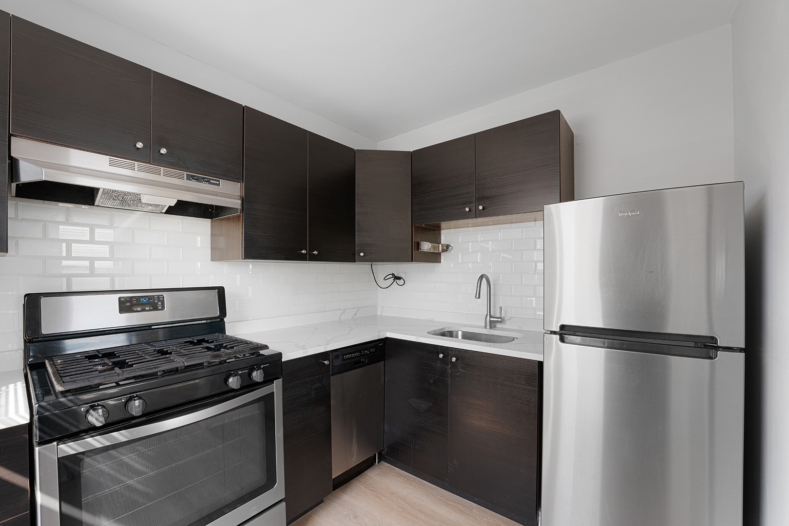 5858 North Sheridan Road, Unit 402 Chicago, IL 60660 - Photo 8 of 16 a kitchen with a refrigerator stove and cabinets