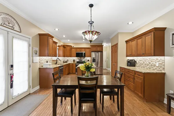 a kitchen with kitchen island granite countertop a sink appliances cabinets and counter space