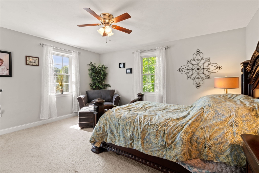 5 Comanche Circle, Unit 5 Haverhill, MA 01835 - Photo 13 of 29 a bedroom with a bed and a chandelier