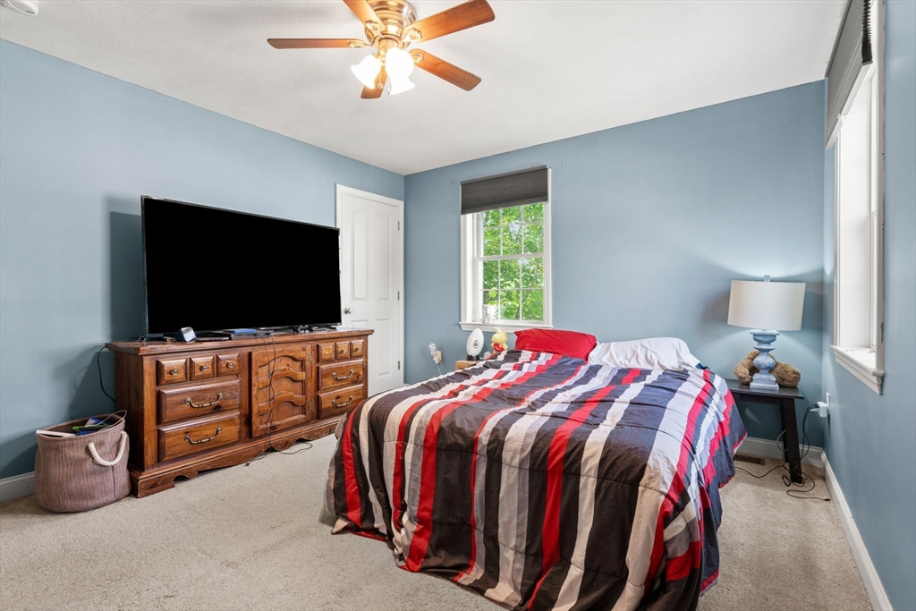 5 Comanche Circle, Unit 5 Haverhill, MA 01835 - Photo 20 of 29 a bedroom with a bed and a flat screen tv