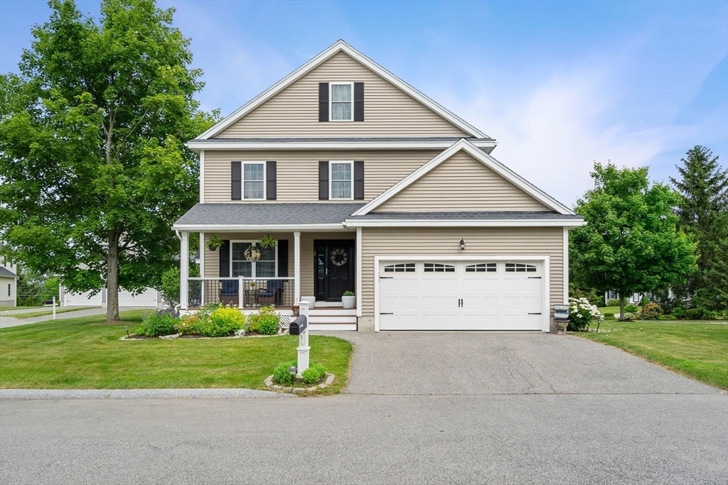 5 Comanche Circle, Unit 5 Haverhill, MA 01835 - Photo 2 of 29 a front view of a house with a yard and garage
