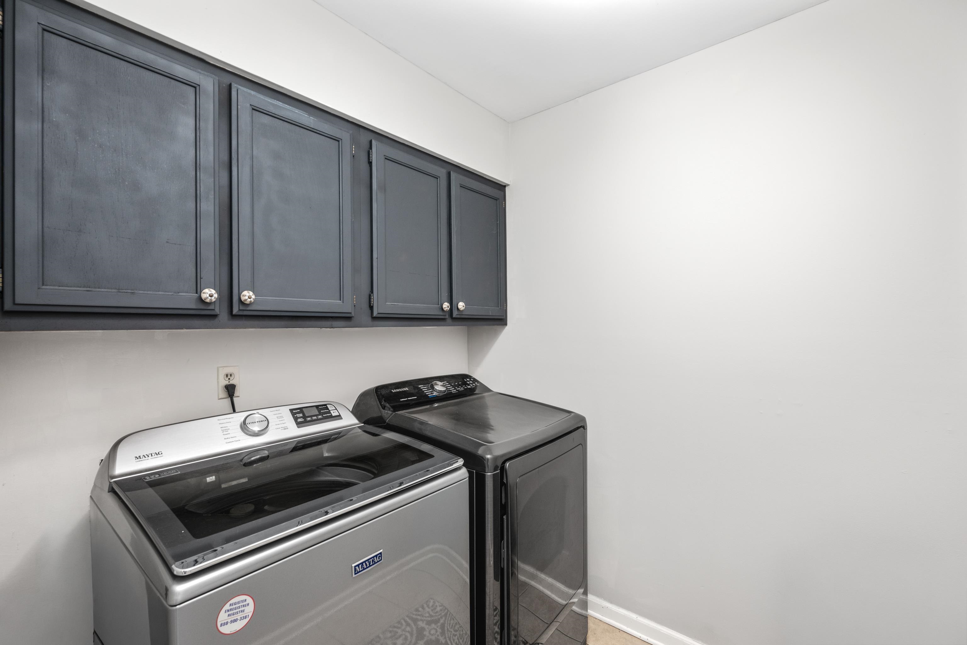608 King Ridge Cove Collierville, TN 38017 - Photo 24 of 32 Laundry area with cabinet space and washing machine and dryer