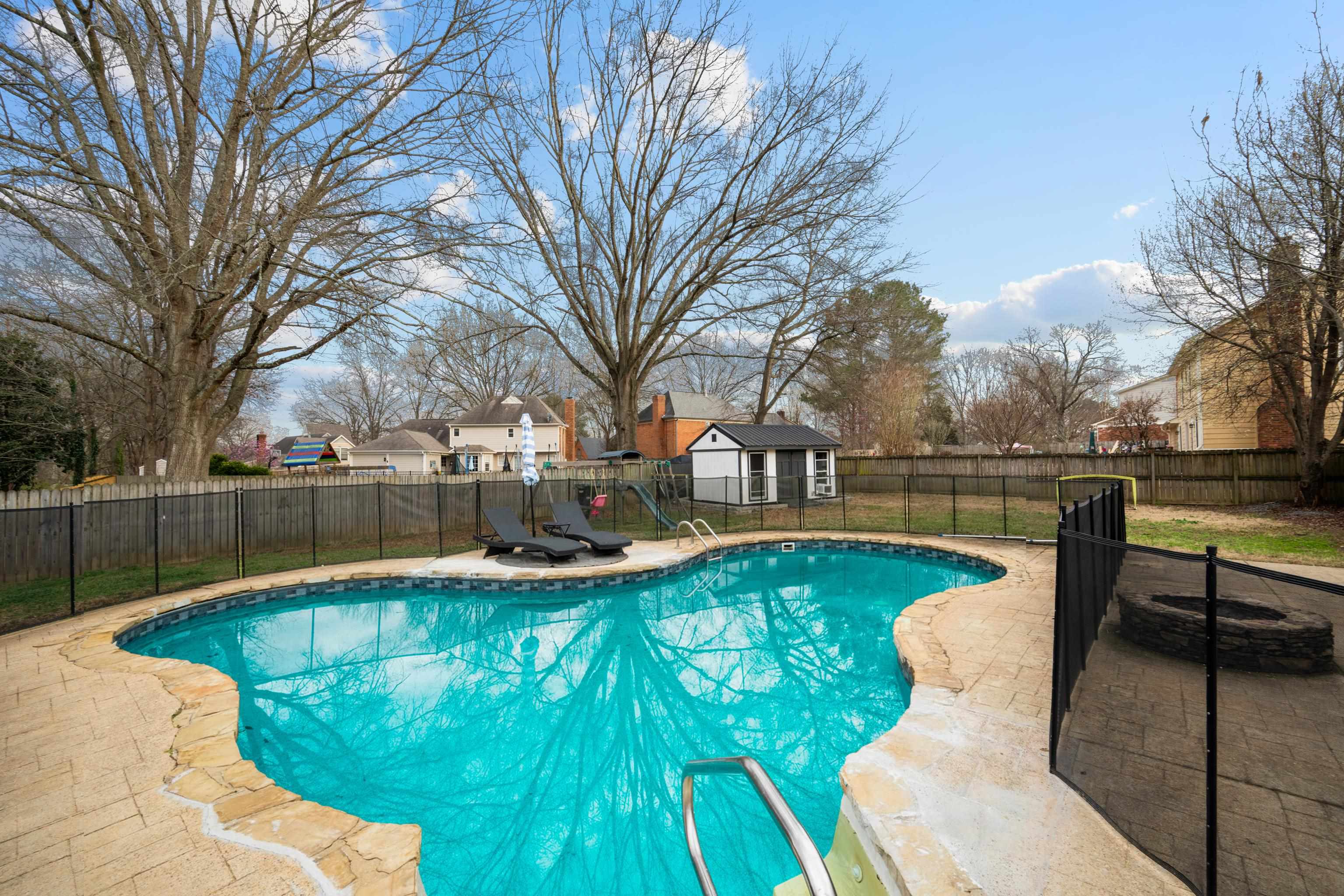 608 King Ridge Cove Collierville, TN 38017 - Photo 26 of 32 View of pool with a fenced backyard, a fire pit, patio surround, a residential view, fire pit, and a storage shed