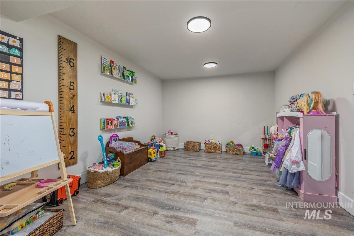 23011 Allendale Road Parma, ID 83660 - Photo 30 of 50 Recessed lighting illuminating walls, wood-finish flooring, and built-in shelving