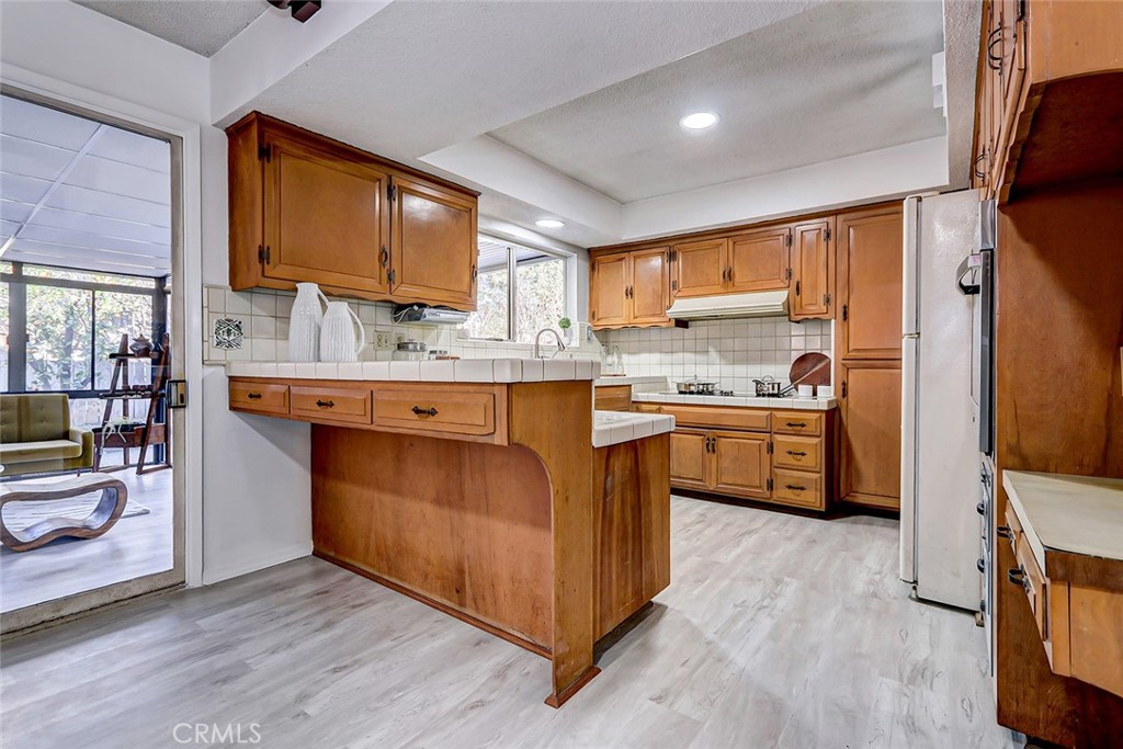2861 Channing Way Rossmoor, CA 90720 - Photo 11 of 39 a kitchen with a sink cabinets and wooden floor