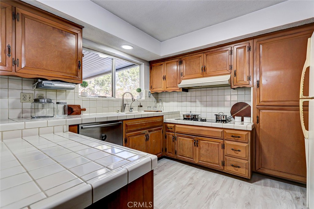 2861 Channing Way Rossmoor, CA 90720 - Photo 12 of 39 a kitchen with stainless steel appliances granite countertop a sink stove and refrigerator