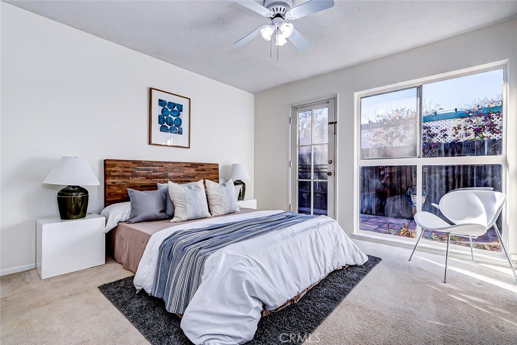 2861 Channing Way Rossmoor, CA 90720 - Photo 21 of 39 a bedroom with a bed a large window and chair