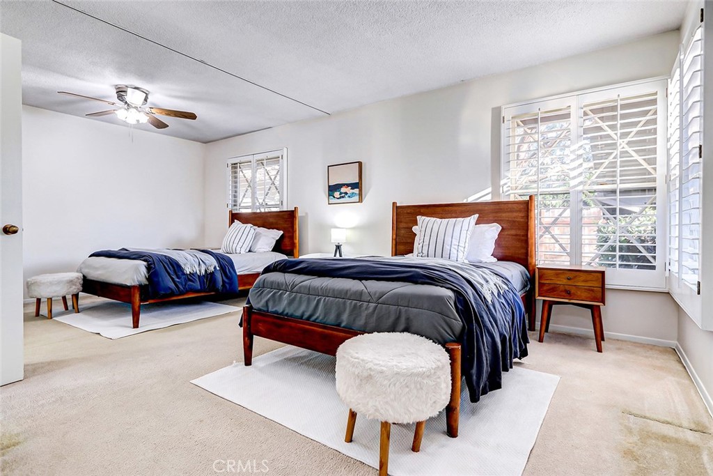 2861 Channing Way Rossmoor, CA 90720 - Photo 23 of 39 a spacious bedroom with a bed and a chandelier
