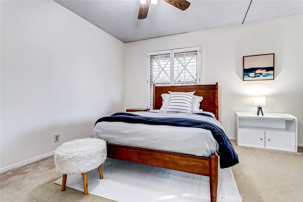 2861 Channing Way Rossmoor, CA 90720 - Photo 24 of 39 a bedroom with a bed and a chandelier