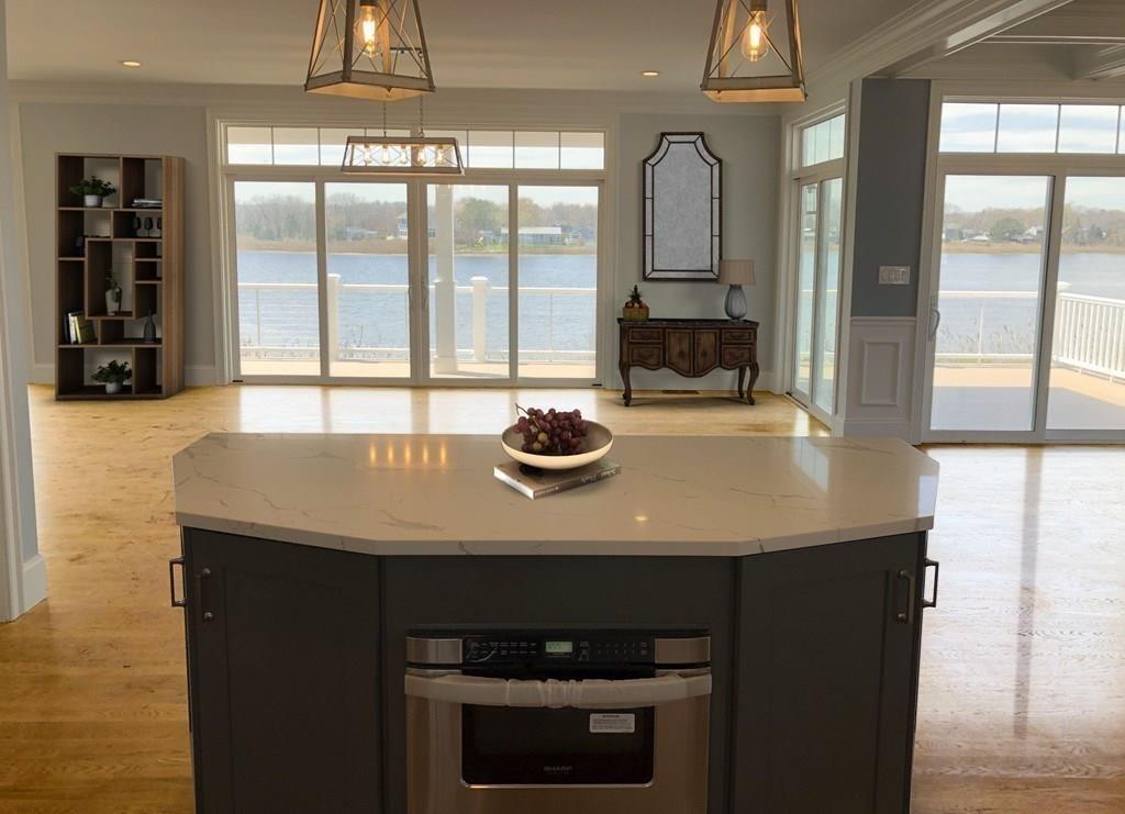70 Surfside Road Scituate, MA 02066 - Photo 11 of 32 a kitchen with a sink a large window and stainless steel appliances