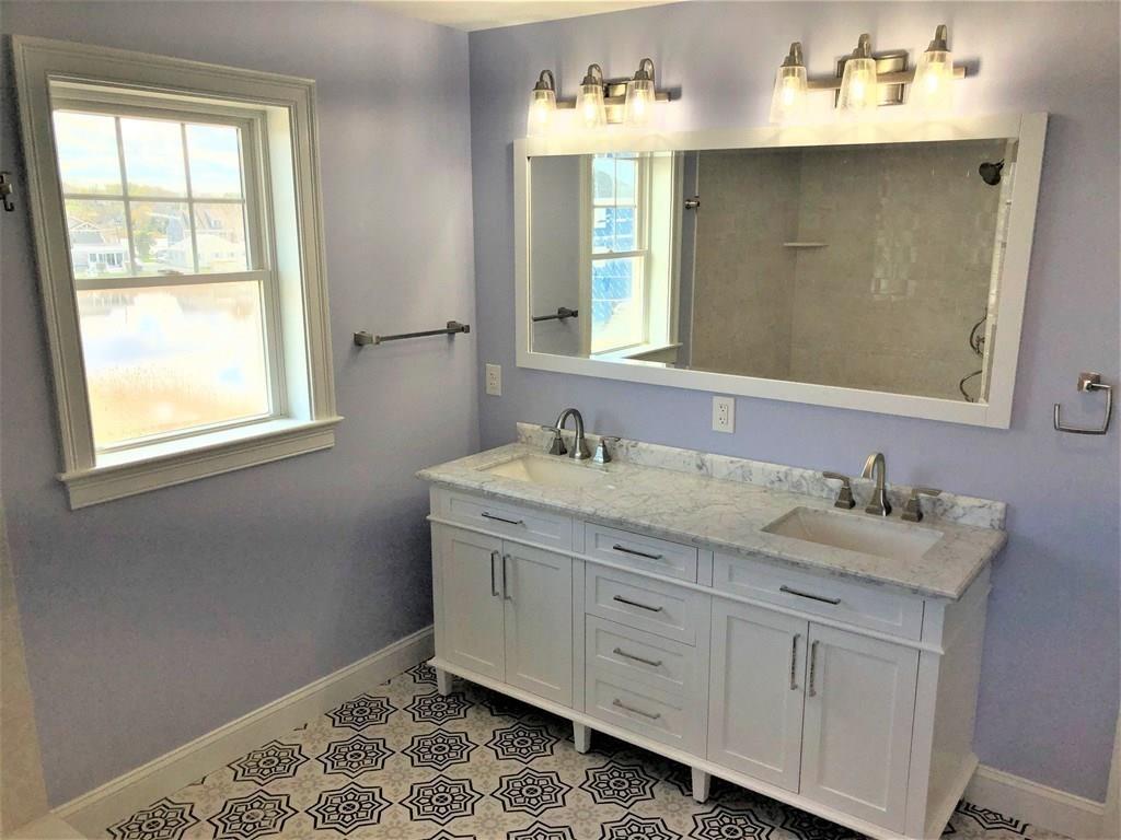 70 Surfside Road Scituate, MA 02066 - Photo 16 of 32 a bathroom with a granite countertop double vanity sink and mirror