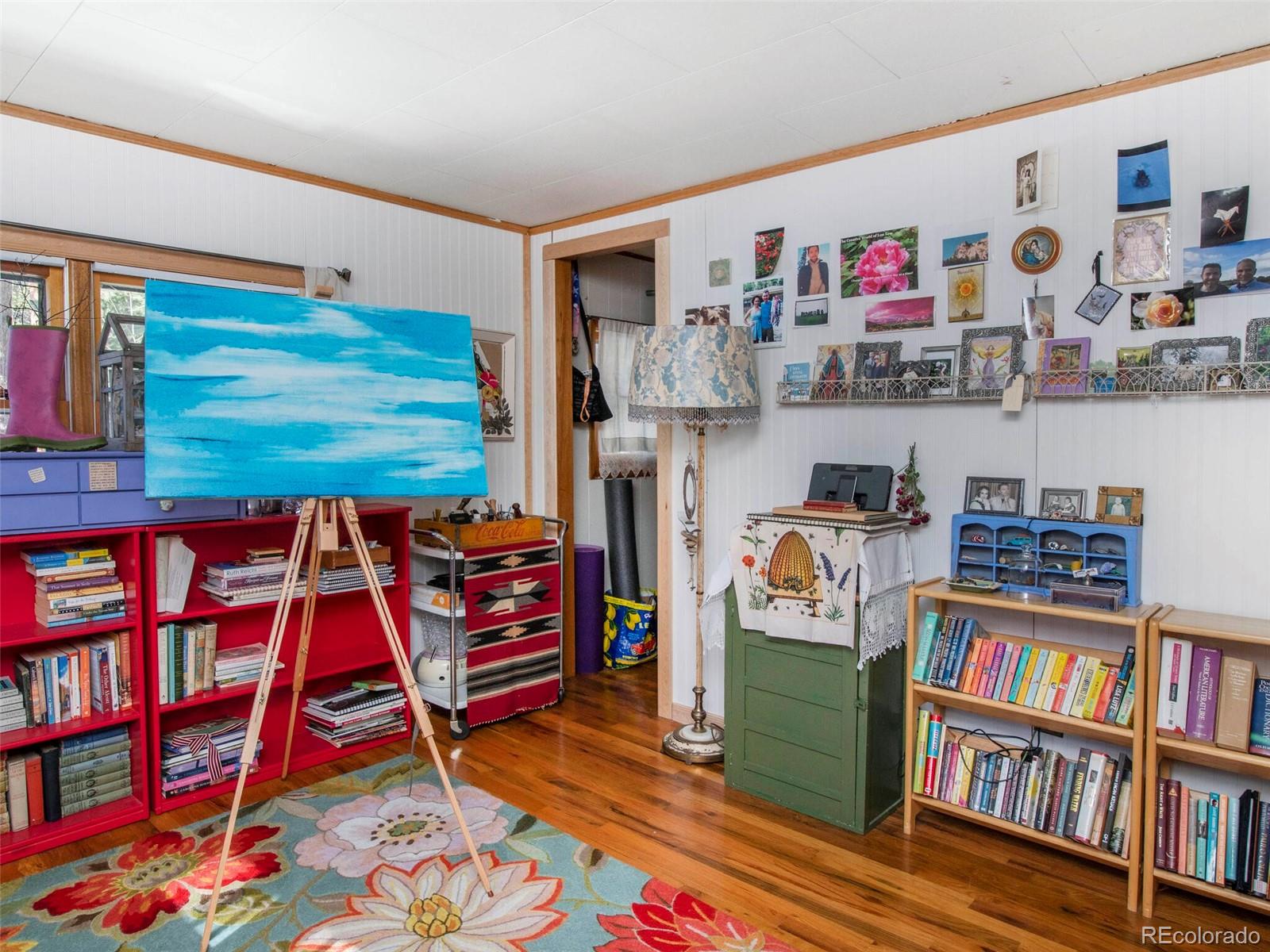 3135 Riverside Drive Lyons, CO 80540 - Photo 18 of 37 a room with furniture and a book shelf