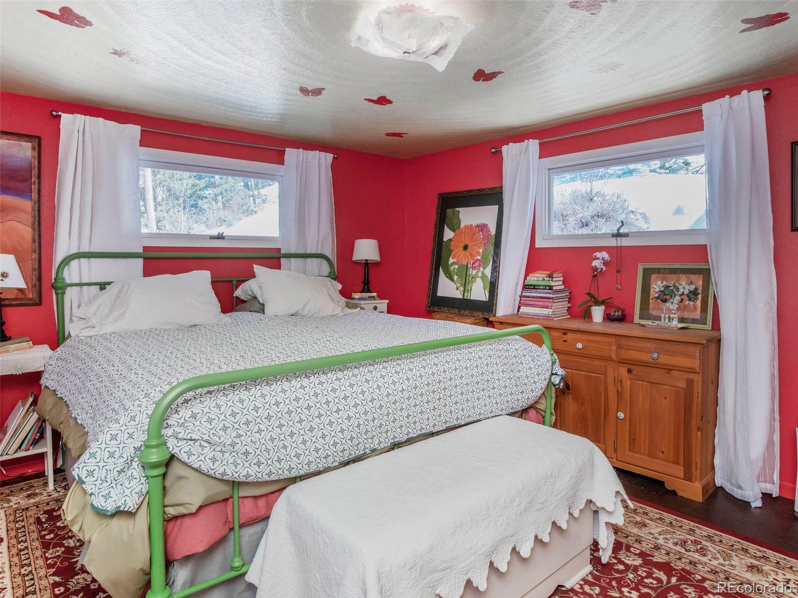 3135 Riverside Drive Lyons, CO 80540 - Photo 19 of 37 a bedroom with a bed and wooden floor