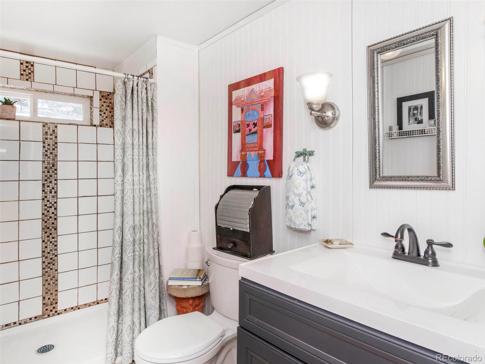 3135 Riverside Drive Lyons, CO 80540 - Photo 21 of 37 a bathroom with a sink toilet and shower