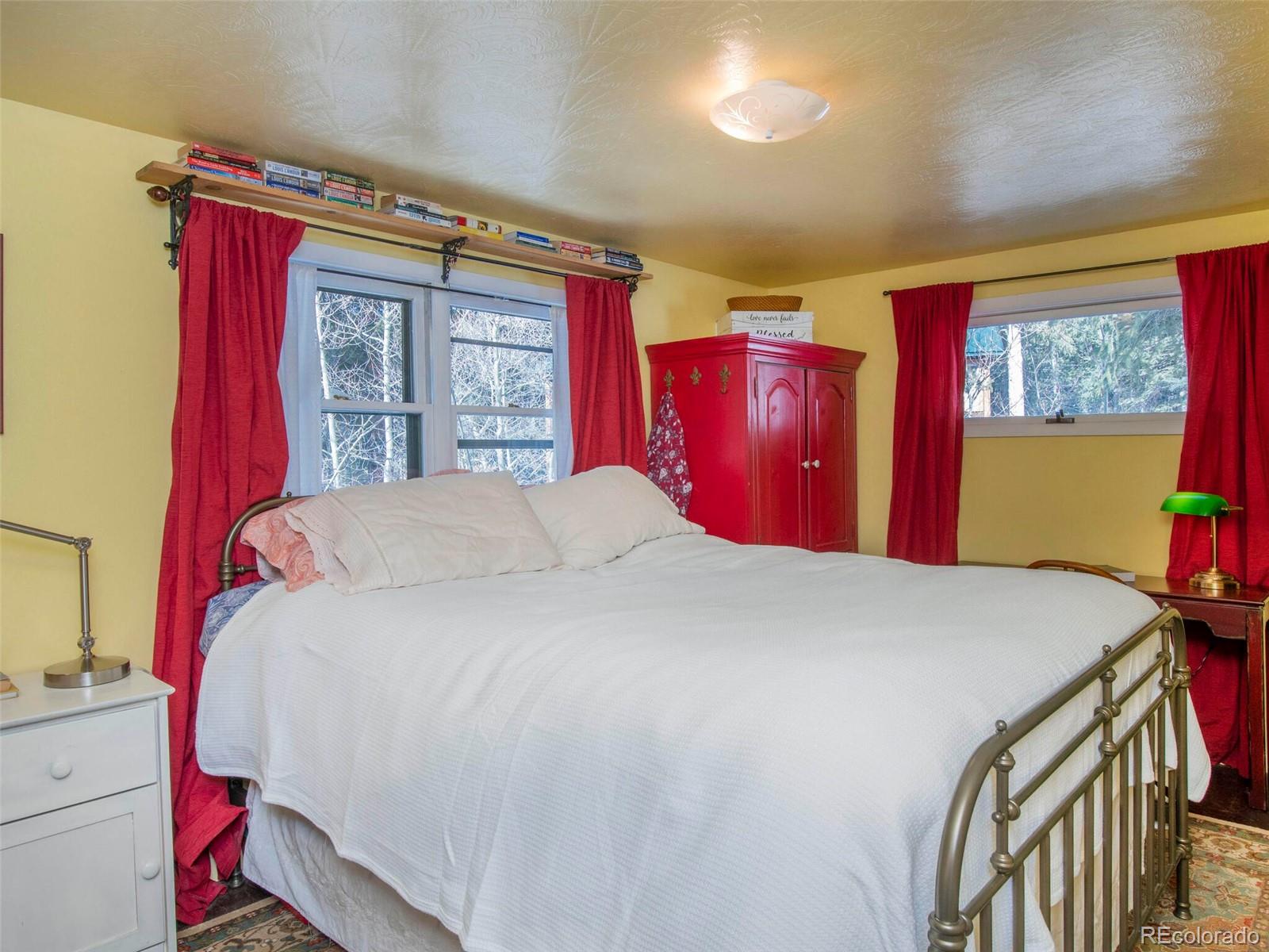 3135 Riverside Drive Lyons, CO 80540 - Photo 24 of 37 a bed sitting in a bedroom next to a window