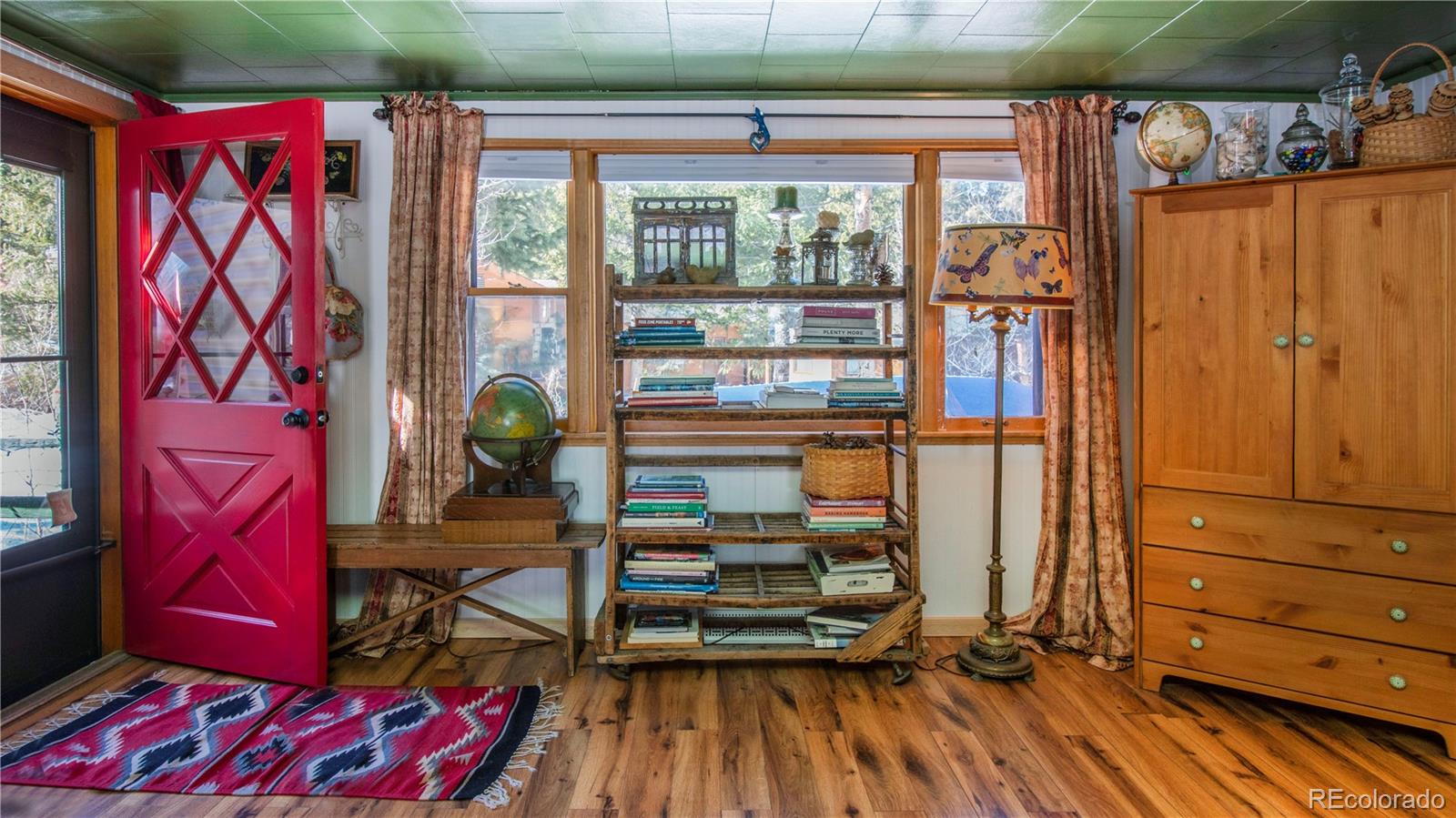 3135 Riverside Drive Lyons, CO 80540 - Photo 4 of 37 a view of a room with wooden floor and windows