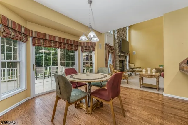 a dining room with furniture and wooden floor