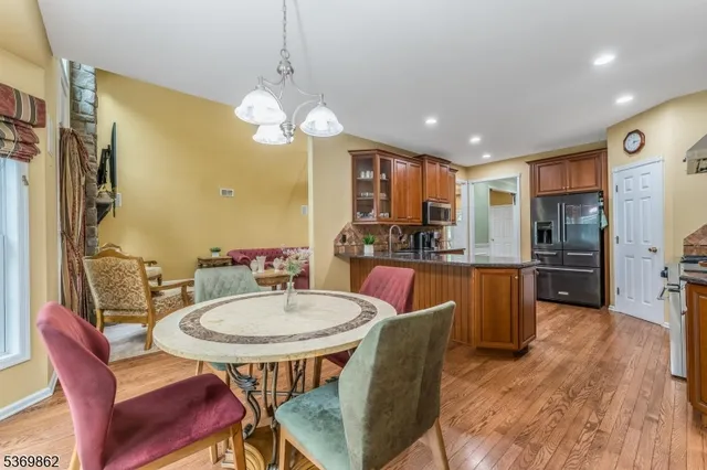 a view of a dining room with furniture a chandelier and wooden floor