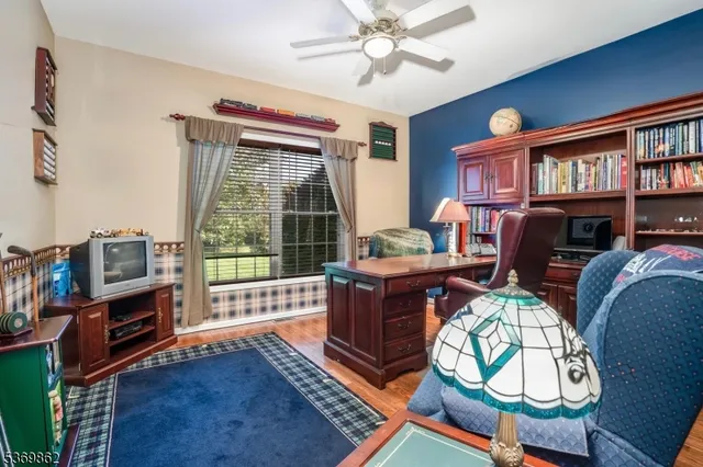 a living room with furniture fireplace and a window
