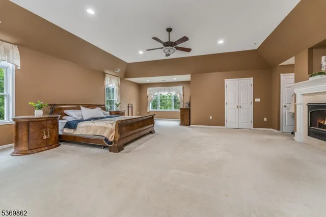 a spacious bedroom with a bed and a chandelier