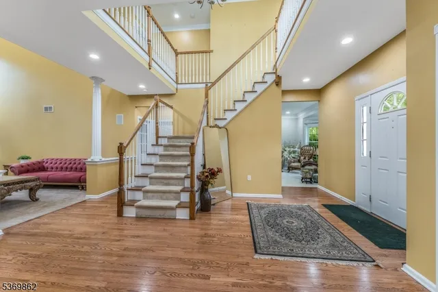 a view of entryway and hall with wooden floor