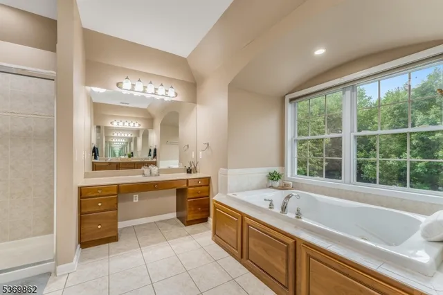 a large bathroom with a large tub and sink