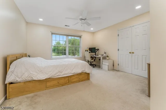 a spacious bedroom with a bed and a window