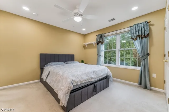 a spacious bedroom with a bed and a large window