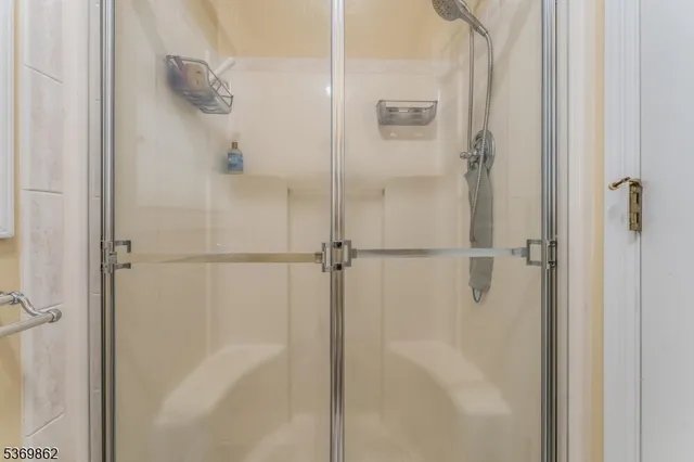 a bathroom with a glass shower door