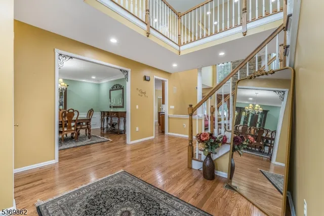 a hallway with wooden floor and furniture