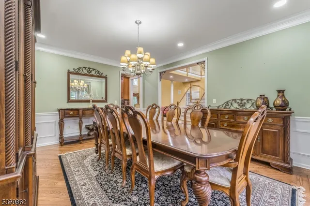 a view of a dining room with furniture and chandelier