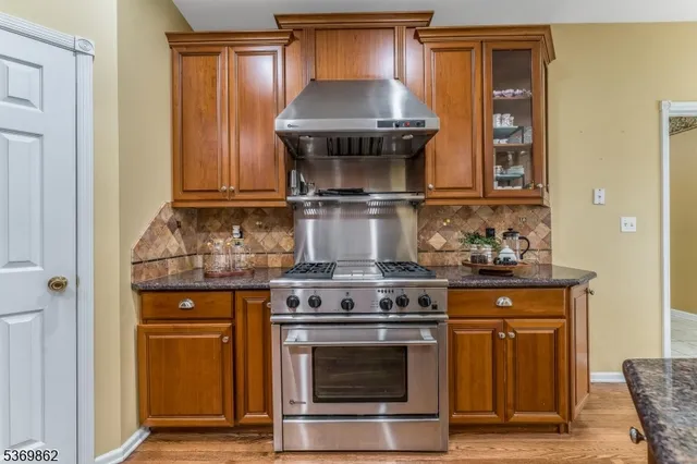 a stove top oven sitting inside of a kitchen