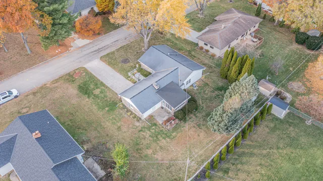front view of a house with a yard and potted plants